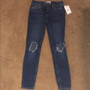 free people denim jeans with two knee rips